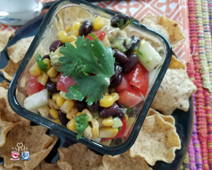 Black Bean and Corn Salad with tomato and avocado is often also called Cowboy Caviar! Check out our Low SmartPoint recipe and easy to make homemade snack!