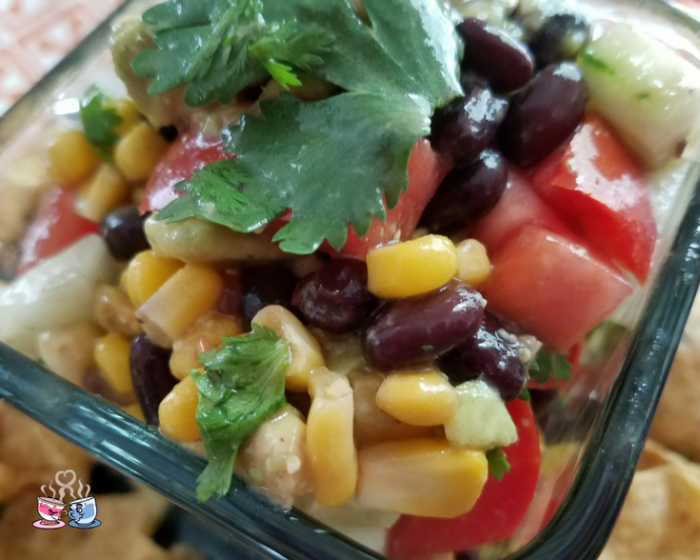 Black Bean and Corn Salad with tomato and avocado is often also called Cowboy Caviar! Check out our Low SmartPoint recipe and easy to make homemade snack!