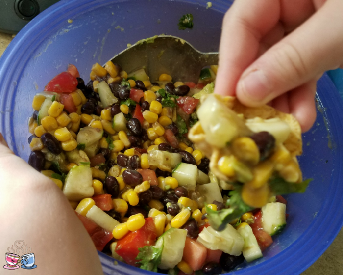 Black Bean and Corn Salad with tomato and avocado is often also called Cowboy Caviar! Check out our Low SmartPoint recipe and easy to make homemade snack!