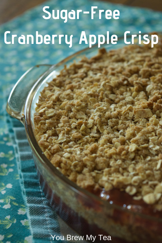 cranberry apple crisp in baking dish laying on a teal napkin