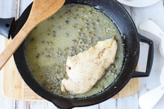 making sauce for chicken piccata in a cast iron skillet