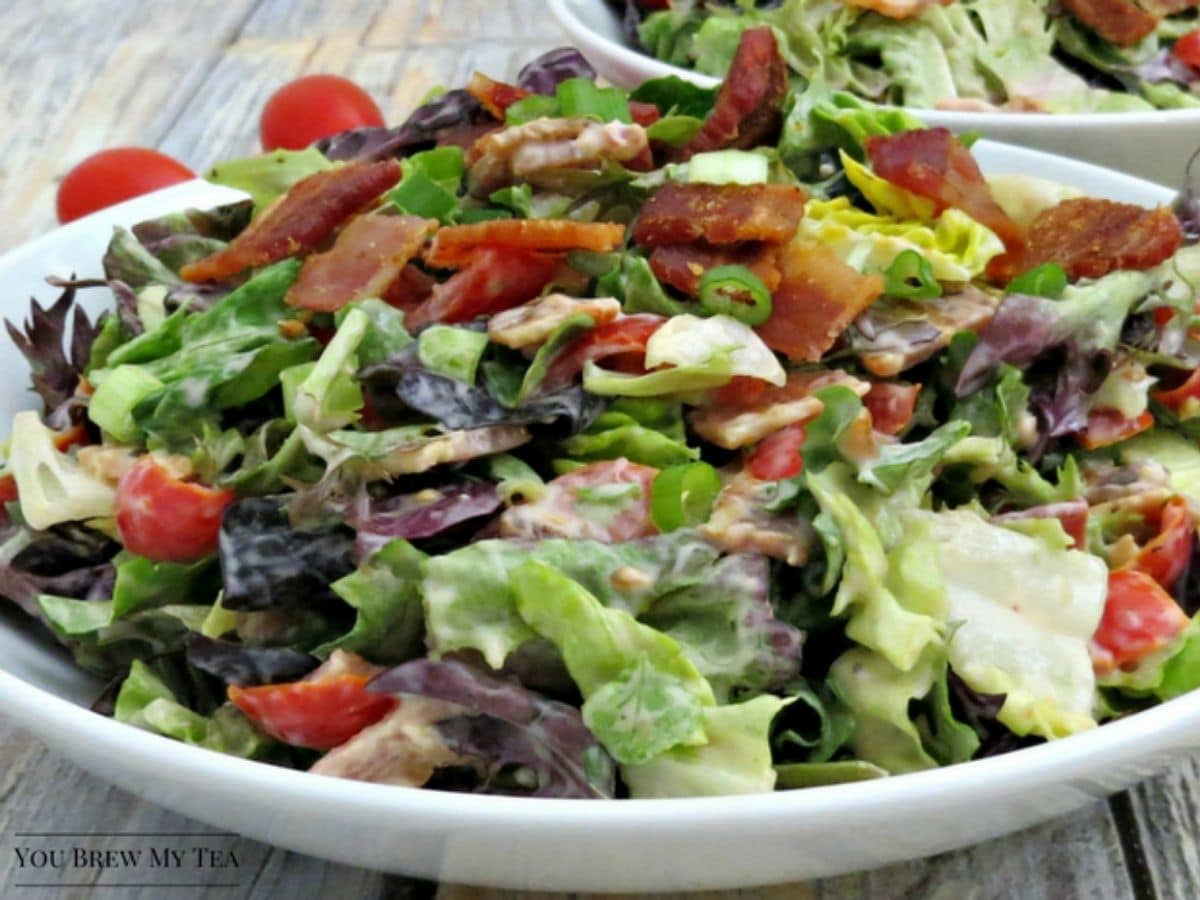 salad with bacon and tomatoes in white bowl