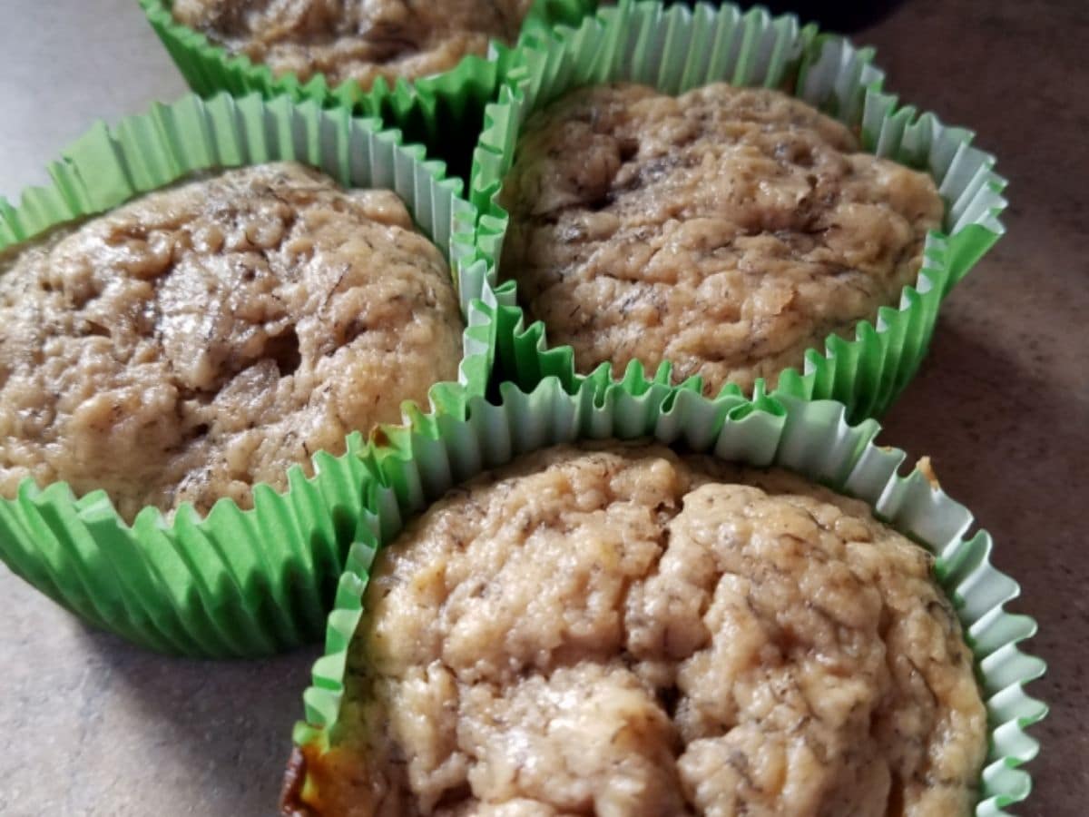 peanut butter muffins in green wrappers on table