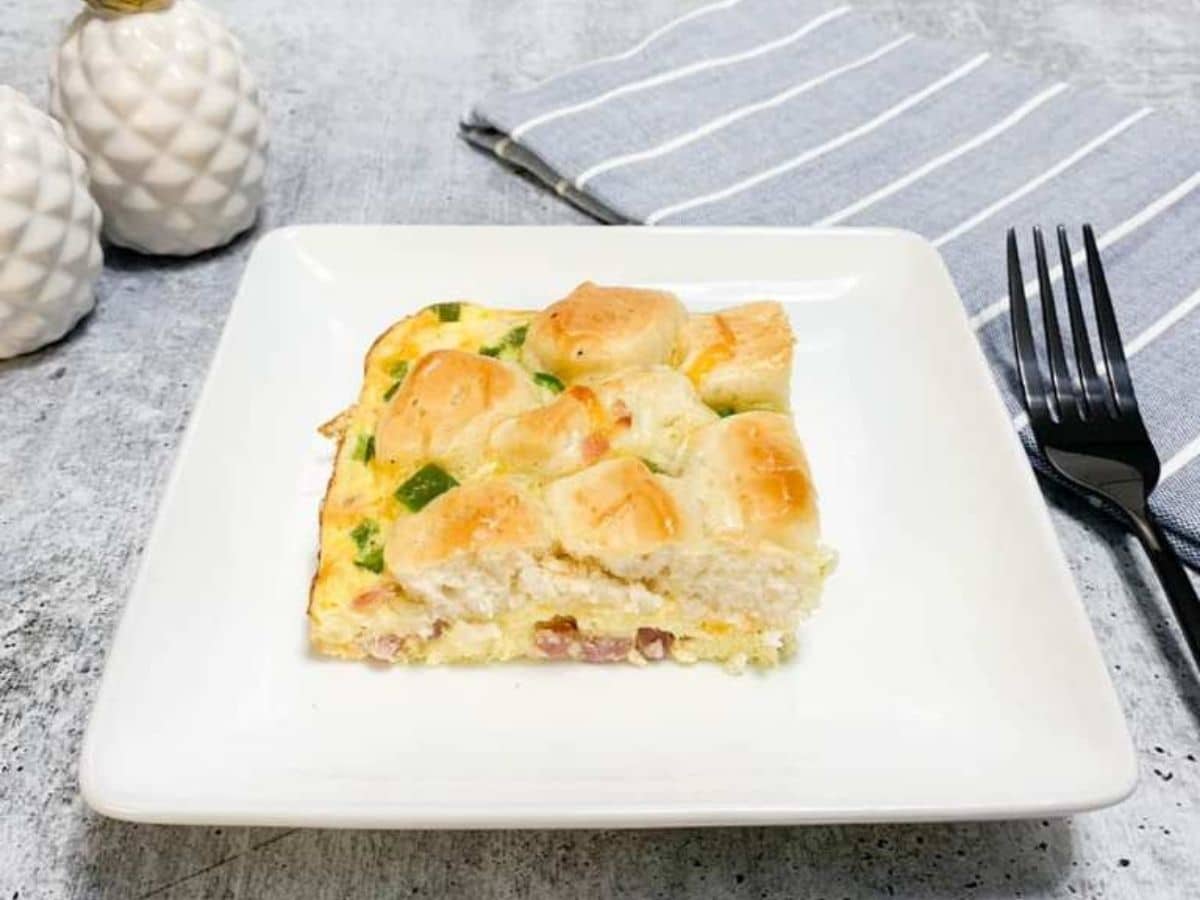 bubble up casserole on square white plate on blue striped napkin