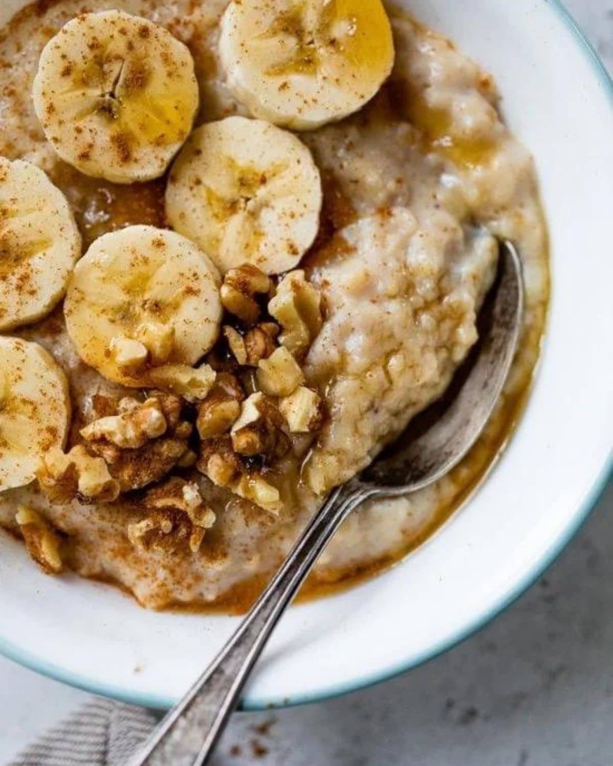 oatmeal in white bowl with sliced bananas on top