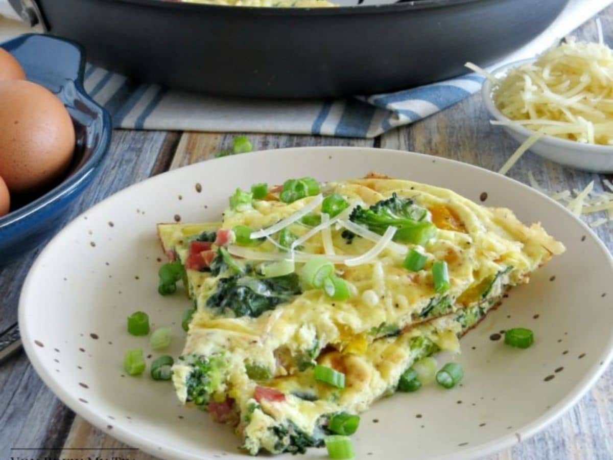 omelet on white plate by cast iron skillet