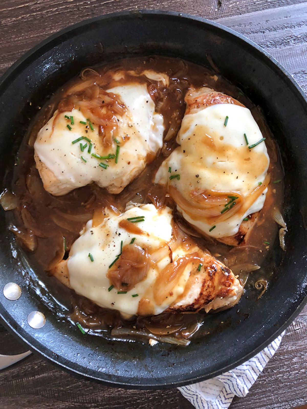 french onion chicken in skillet on table