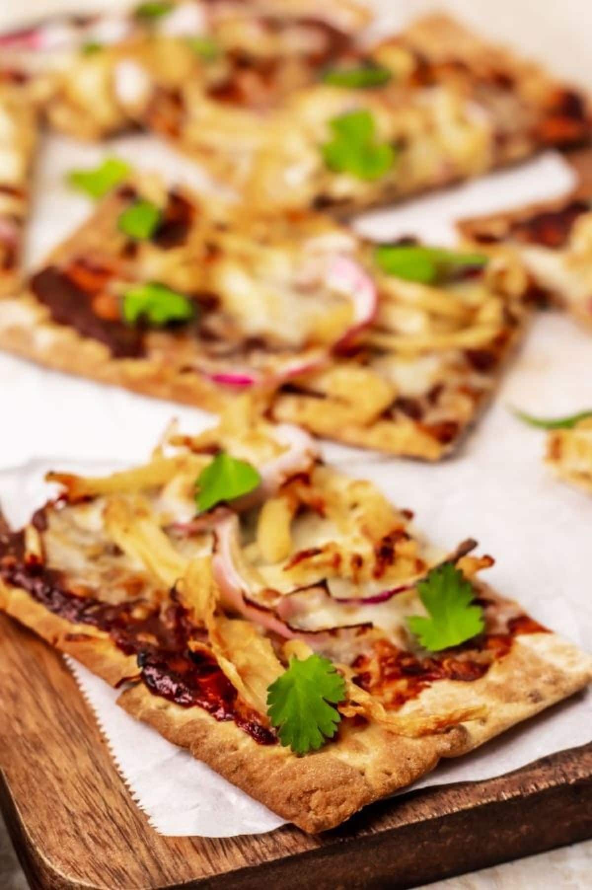 chicken pizza on wooden cutting board