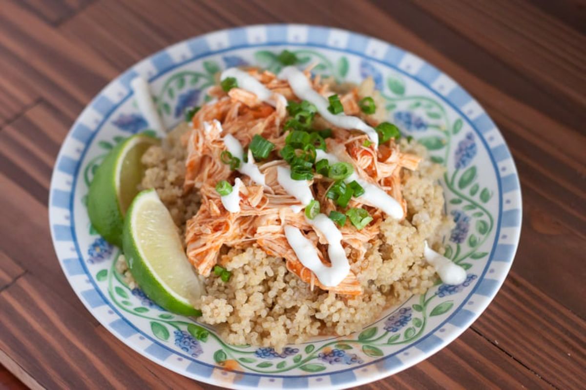 salsa chicken on top of rice in white and blue bowl