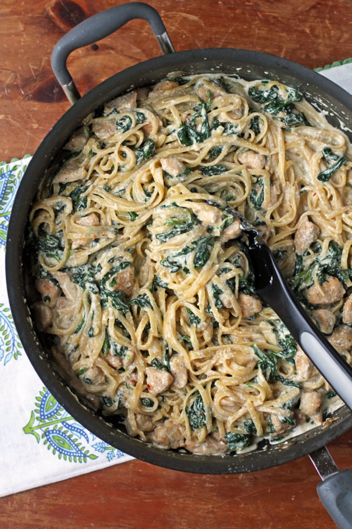 black sillet of pasta with tongs inside