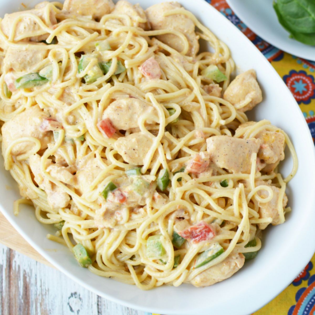 chicken spaghetti in white bowl on table