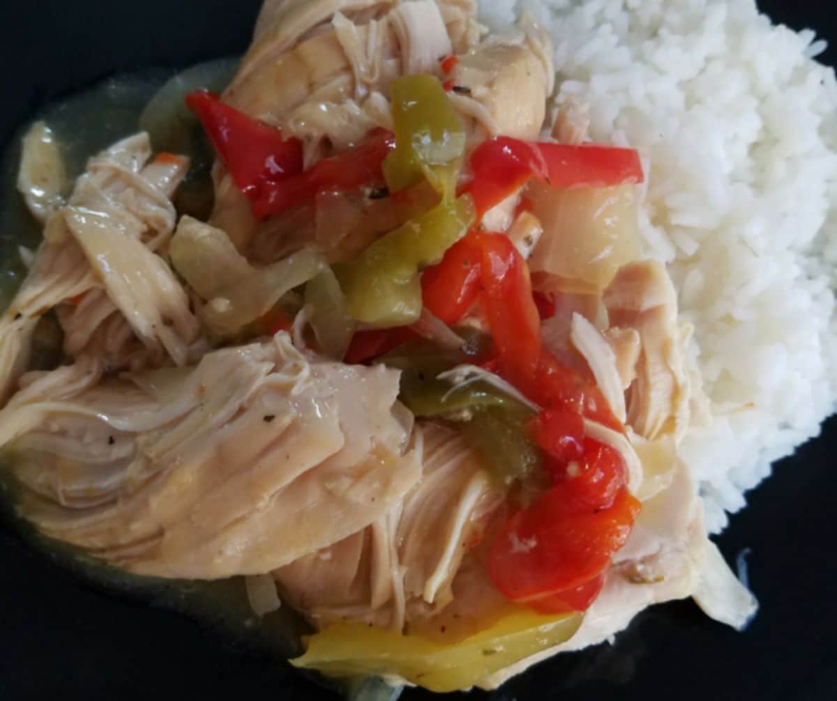 chicken and peppers by rice on black plate