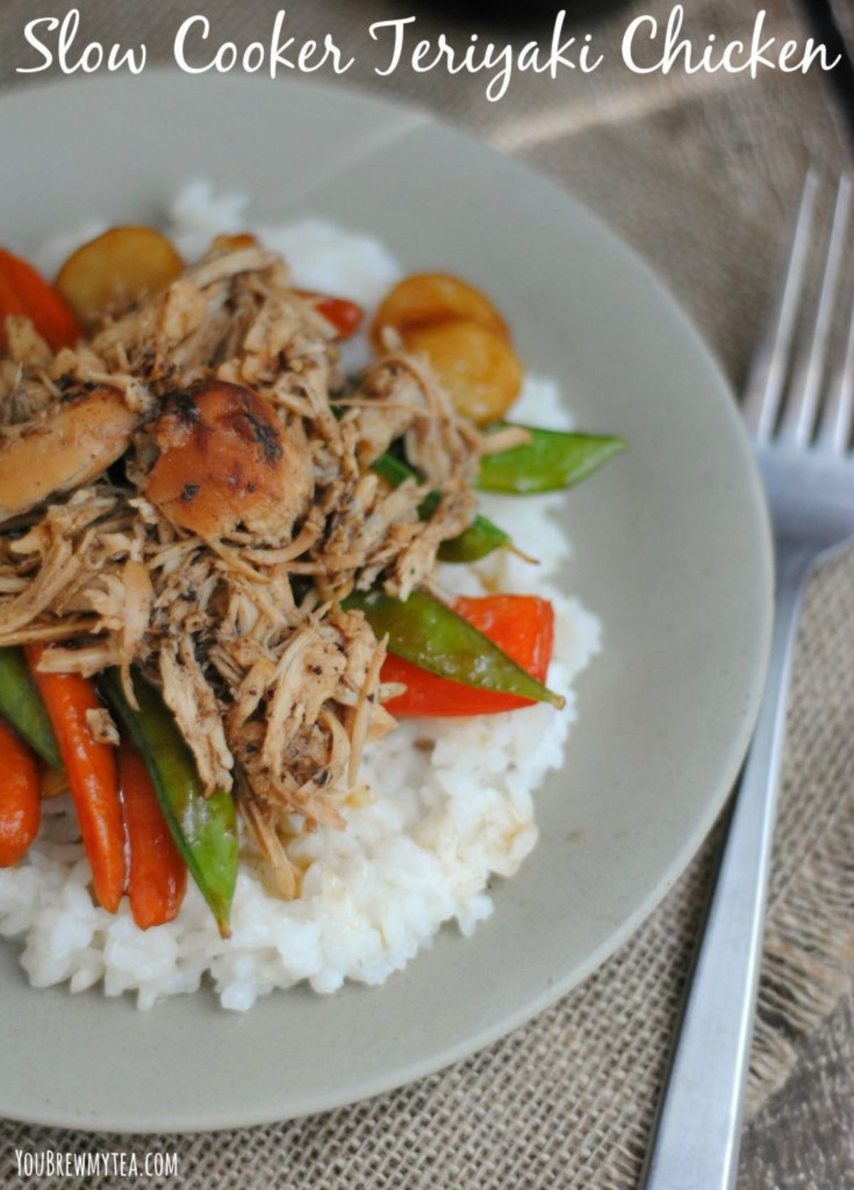 chicken and vegetables on top of rice on gray plate