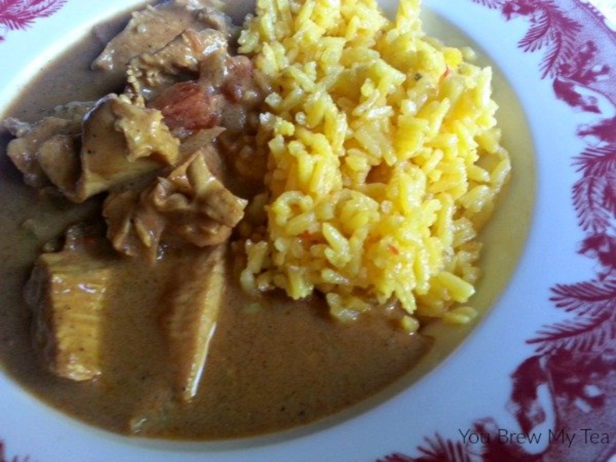 curry with rice in red and white bowl