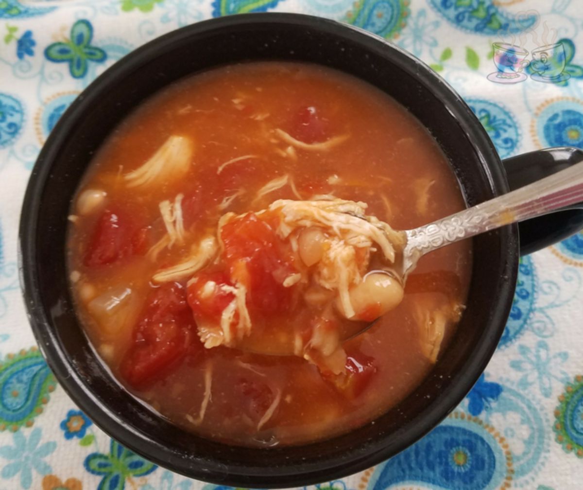 black bowl of soup on teal paisley napkin