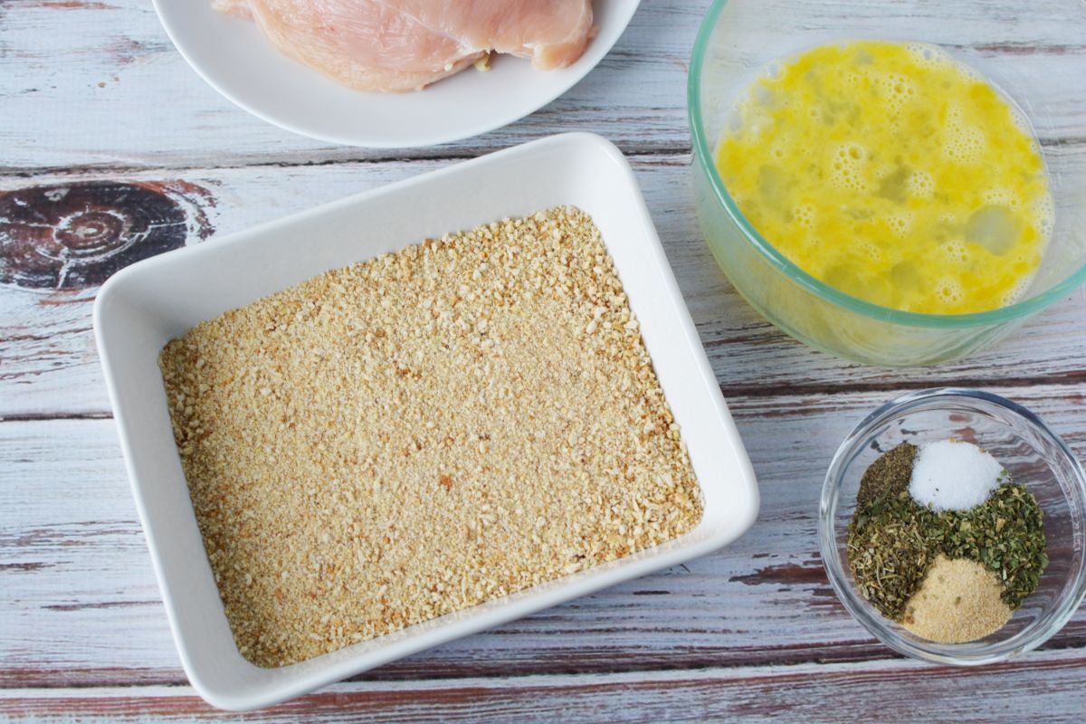 white bowl of breadcrumbs on wood table