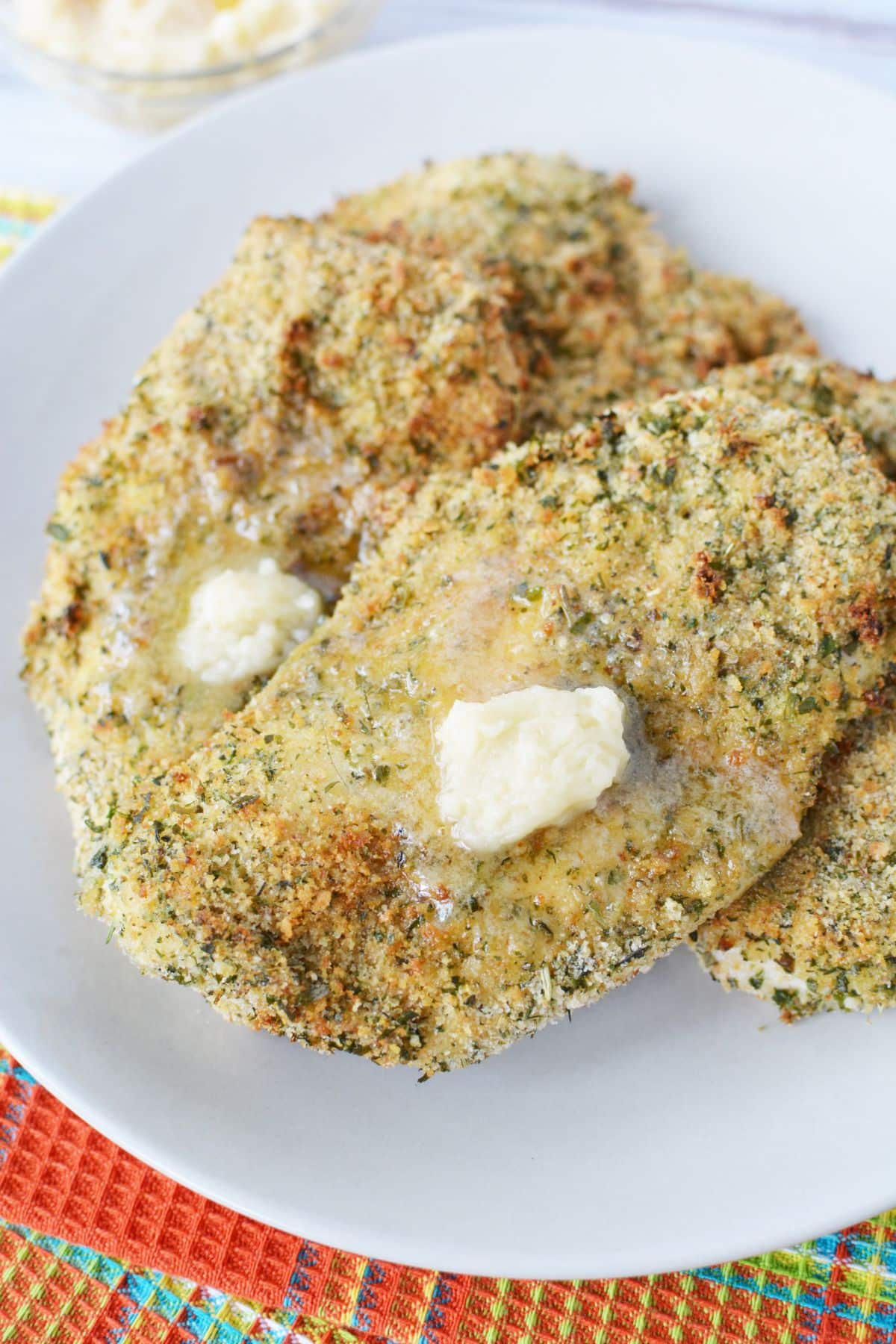 round white plate holding cooked crispy chicken