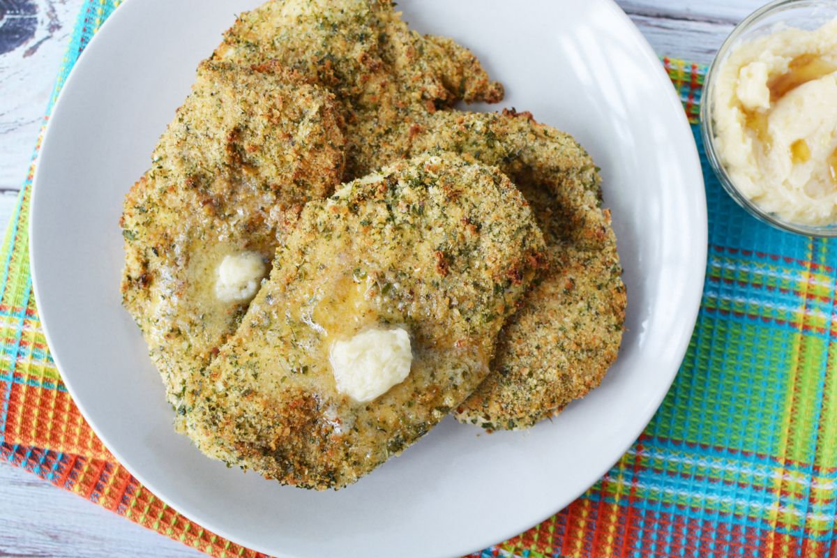 plate of crispy herbed chicken breasts