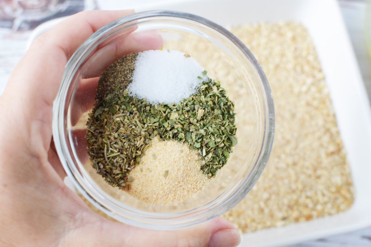 small glass bowl of herbs and salt