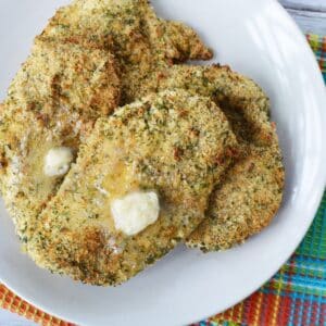 plate of crispy herbed chicken breasts