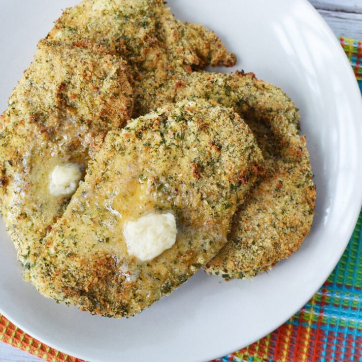 plate of crispy herbed chicken breasts