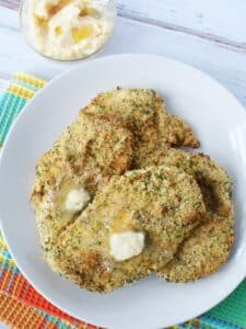 plate of crispy herbed chicken breasts