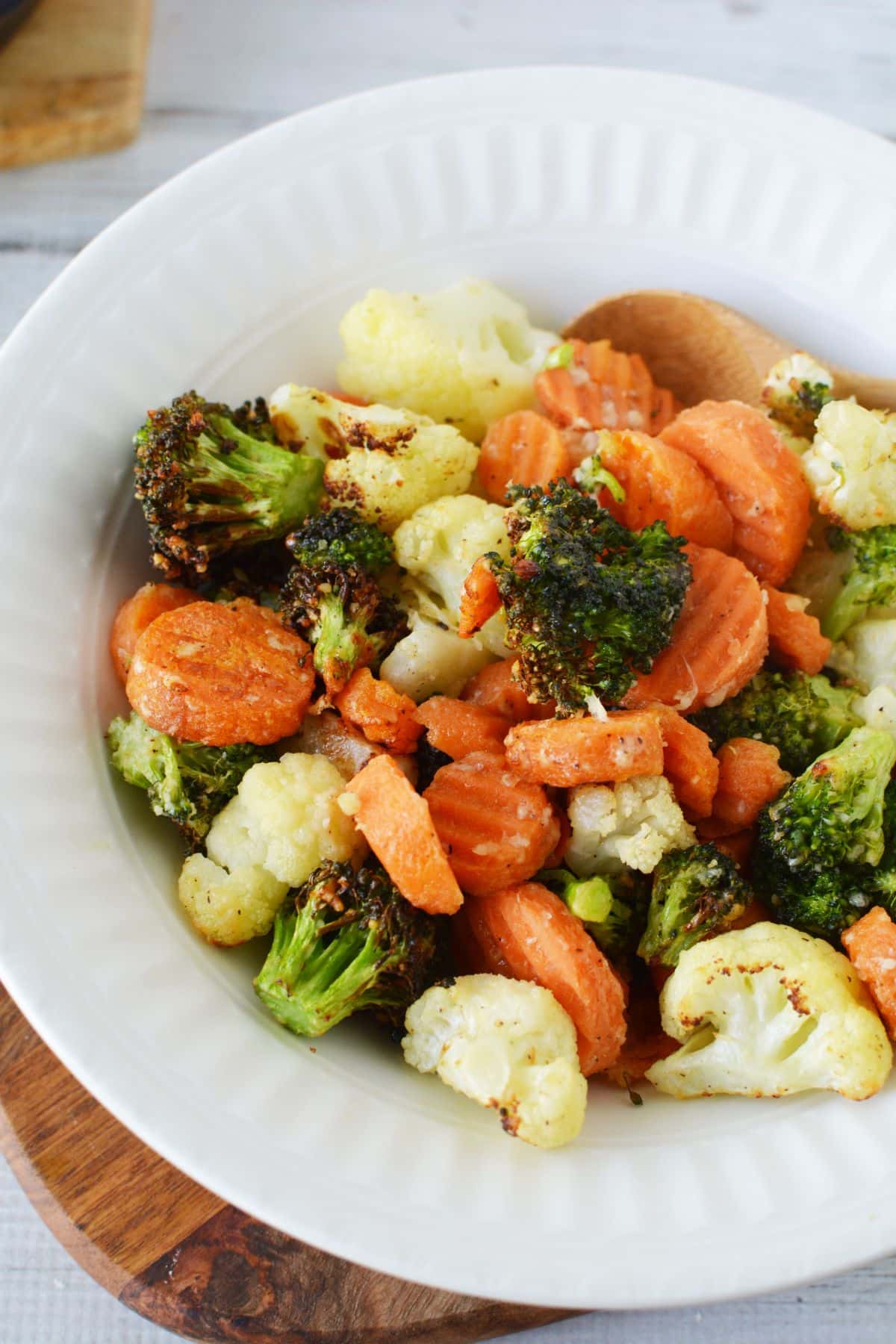 bowl of vegetables including broccoli cauliflower and carrots